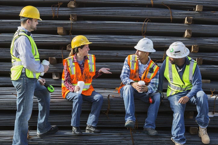 Construction workers chat while on a break at work